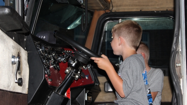 Kids enjoyed getting to play trucker behind the wheel of real big rigs.